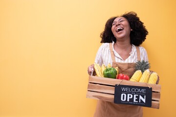 Portrait smiling happy young African woman Agricultural business owner holding wooden basket fruit...