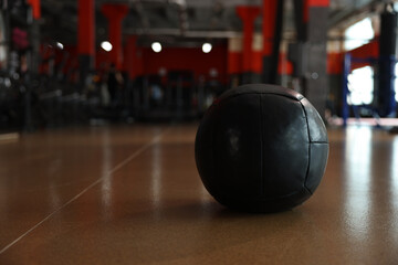 Naklejka na ściany i meble Medicine ball on floor in gym. Space for text