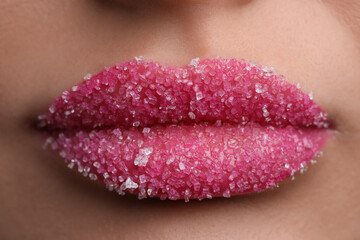 Young woman with beautiful lips covered in sugar, closeup