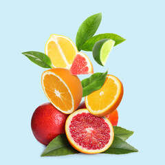 Fresh juicy citrus fruits on turquoise background