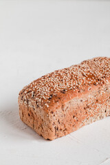 Fresh loaf of sesame bread on a white background. Copy space.