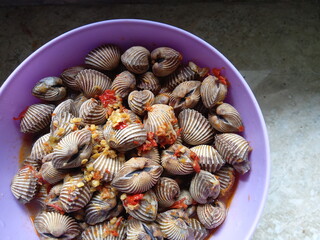  Boiled cockles,  blood clams seasoned with red onion, garlic and cayenne pepper. placed in a...