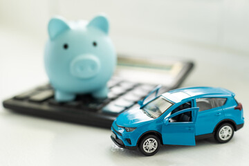 toy car and piggy bank on white background