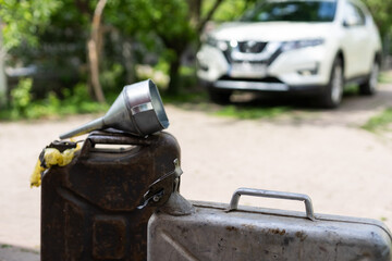 canister and watering can for diesel. the canister with the fuel and the filler funnel.
