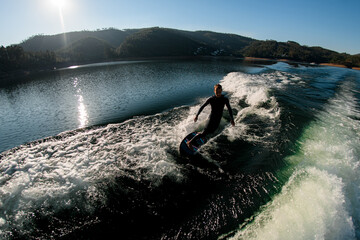high angle view of man masterfully riding with wakesurf board on a wave