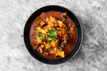 healthy plant-based food, vegan turkish güveç hot pot with eggplant celeri and potaotes in spicy broth with mixed herbs