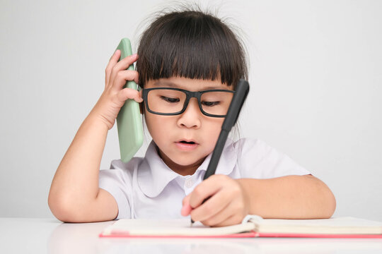 Little business woman with laptop working in office while talking on the phone Children and business concepts