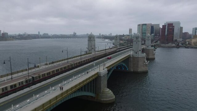 Tracking Of Subway Red Line Train Passing On Longfellow Bridge Over Wide Charles River On Cloudy Day. Boston, USA