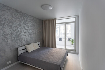 Gray bed and bright sunshine