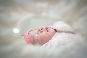 First day of Asian newborn baby sleep in Incubator at nursery room.