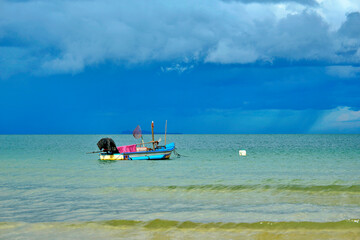 Fishing boat with the amazing sky background after raining, Ranong province Thailand.