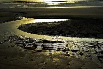 Wavy sand pattern background, Sea waves crashing against the beach.