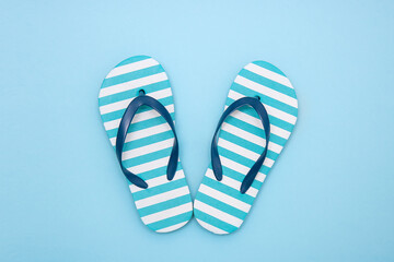 children's beach flip-flops on a blue background