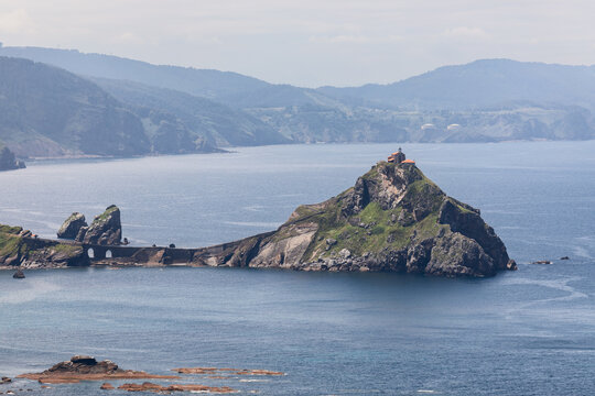 Panoramic shot of rocky island of Gaztelugatxe has been the scenario of pirates covens and legends,&nbsp;picturesque chapel on top. Basque coastline, Bermeo, Spain