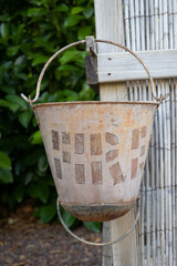 Brown old rusty bucket in a farm