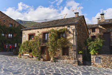Typical house from the northern mountains of Guadalajara (Spain) with a slate roof, stone walls with vegetation.