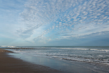 Morning sky with fluffy white clouds at beach, New Plymouth, New Zealand.