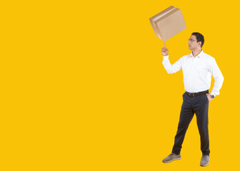 Small business owner. Businessman with cardboard box on his finger. Man business owner. Human in business suit with box. Guy with package on yellow. Online store owner with cardboard box