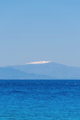 Seascape of the ocean in Rhodes Greece showing in the background a mountain top with snow