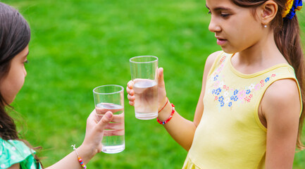 children drink clean water in nature.selective focus