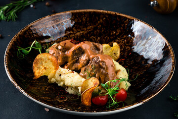 Traditional German braised beef cheeks in brown red wine sauce with spaetzle herbs - obrazy, fototapety, plakaty