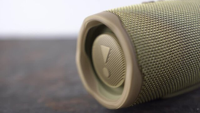 Ukraine, Dnipropetrovsk 03.11.2021 JBL Portable Bluetooth Speaker. The speaker membrane in the sound column while playing music. Close-up footage of portable speaker.