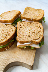 deli meat sandwich with turkey close up shot with selective focus and toast bread.