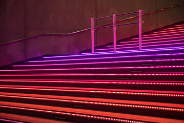 Night view of staircase light up in red, purple, pink