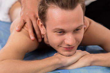 Fototapeta na wymiar Relaxed head massage the professional masseur doing to his client on medical clinic concept of healthy body and skin spa salon