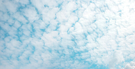 overcast turquoise sky with fleecy clouds