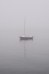 Small sailboat in the fog
