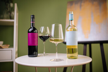 Bottles and glasses of white and red wine with grapes