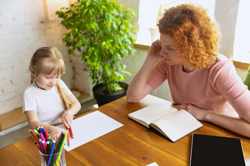 Professional female therapist communicate with child during extracurricular activities. Drawing, counting and social adaptation. Concept of support, studying, childhood,