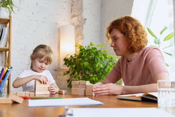 Young therapist woman speaking with child, counselor and behaviour correction at the office....