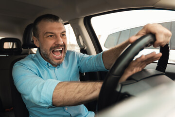 Angry man driving car shouting and honking