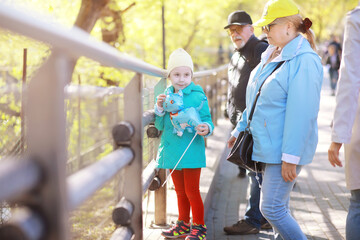 Family with children for a walk in the summer park. Сoming autumn in the park. Family. Fall. Happiness.