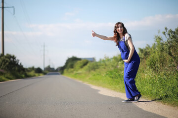 Fototapeta na wymiar Pregnant woman on the road stops the car