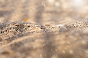 Close up beauty of beach sand with bokeh. Soft texture selective focus. Copy space for design. Wallpaper. Background.