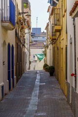 View of old street in Dalt la Vila, building with colored facade, historic center of Badalona, province of Barcelona, Spain.