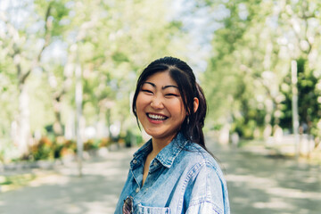 Portrait of a smiling young asian adult woman.