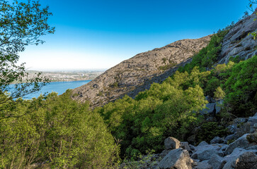 Fototapeta na wymiar A scenic view to slopes of Lifjel, Gandsfjord and Stavanger suburbs from a hiking trek, Sandnes, Norway, May 2018