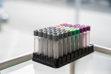 A set of test tubes with lids on a stand in the cosmetologist's office. 