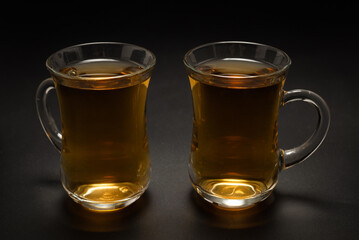 A turkish glass of tea on black background.