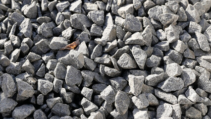 Full frame background showing pieces of small grey slate or granite