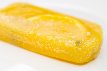angle view fresh passion fruit flavor popsicle with slice of orange on a dish