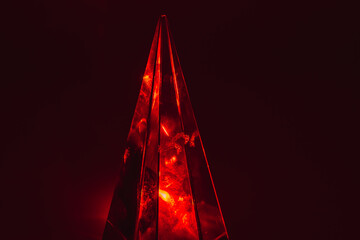 red Glass pyramid prism on black background