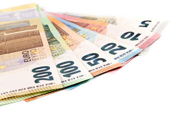Euro banknotes of various denominations on a white background