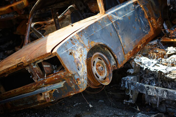 A lot of rusty burnt cars in Irpen, after being shot by the Russian military. Russia's war against Ukraine. Cemetery of destroyed cars of civilians who tried to evacuate from the war zone