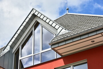 Fototapeta premium Gaube mit Stehfalz-Metall-Verkleidung des Dachgeschosses an einem modernen Verwaltungsgebäudes
