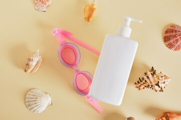 white mockup bottle for cosmetics without a label and seashells on a beige background